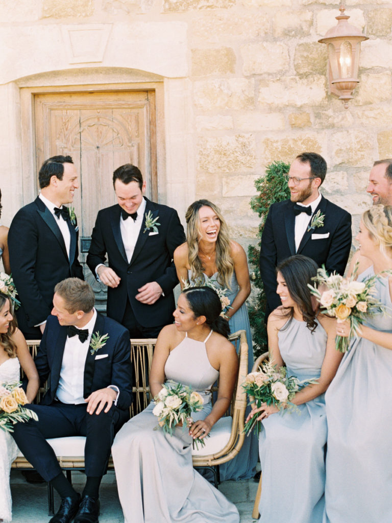 candid wedding photo of the wedding party laughing at sunstone winery