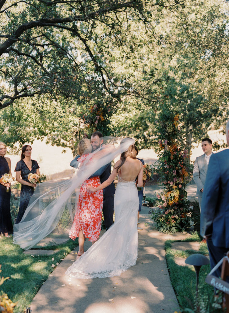 bride walking down the ceremony at a private estate garden wedding in Napa valley